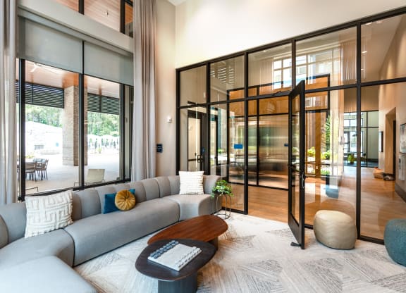 a living room with a gray couch and a coffee table at Preston Ridge, Cary, NC